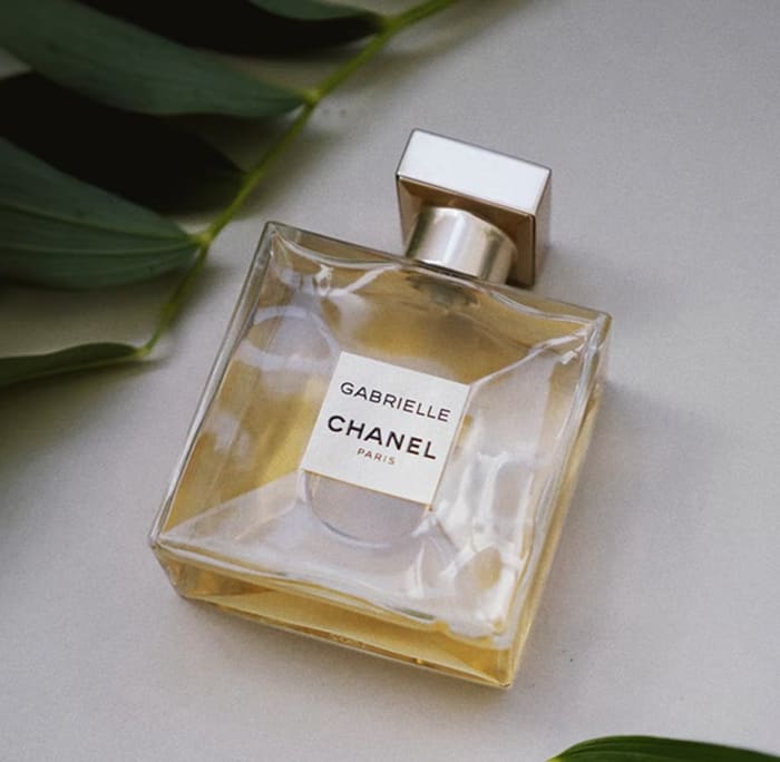 Perfume on table with decorative background